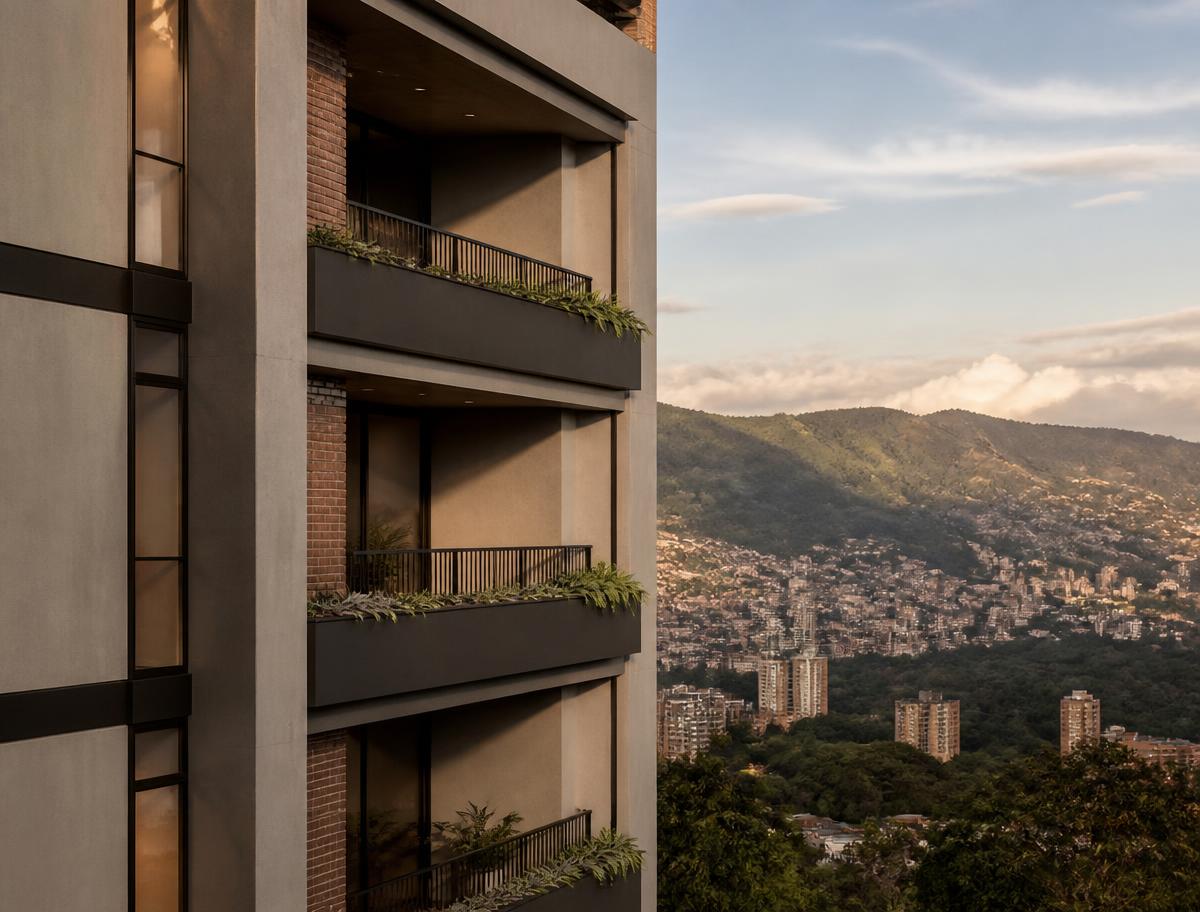 Fachada de un edificio residencial moderno al atardecer con montañas verdes al fondo